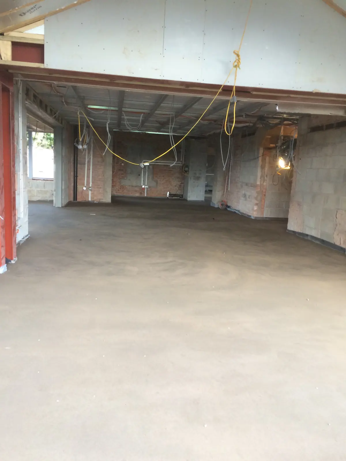 Screeded floor in a large open room before the finishes