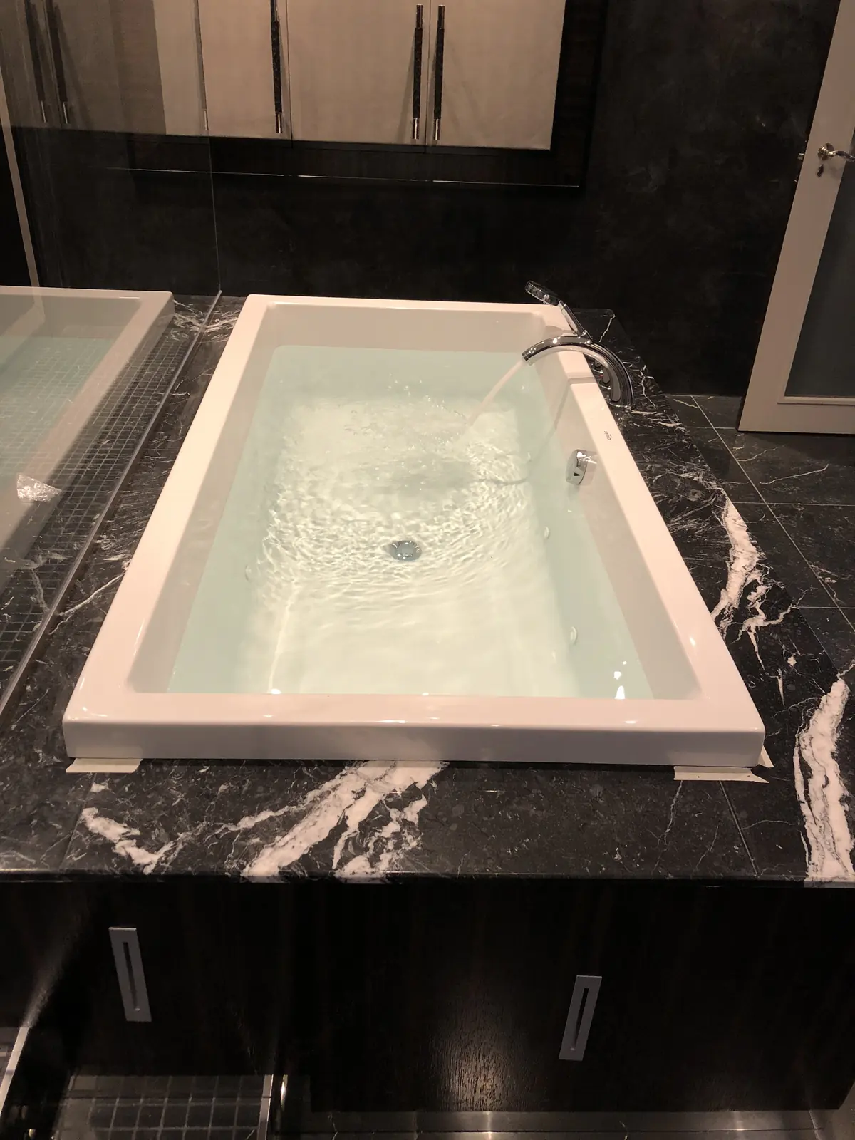 Shower with a rainfall head and a towel rail